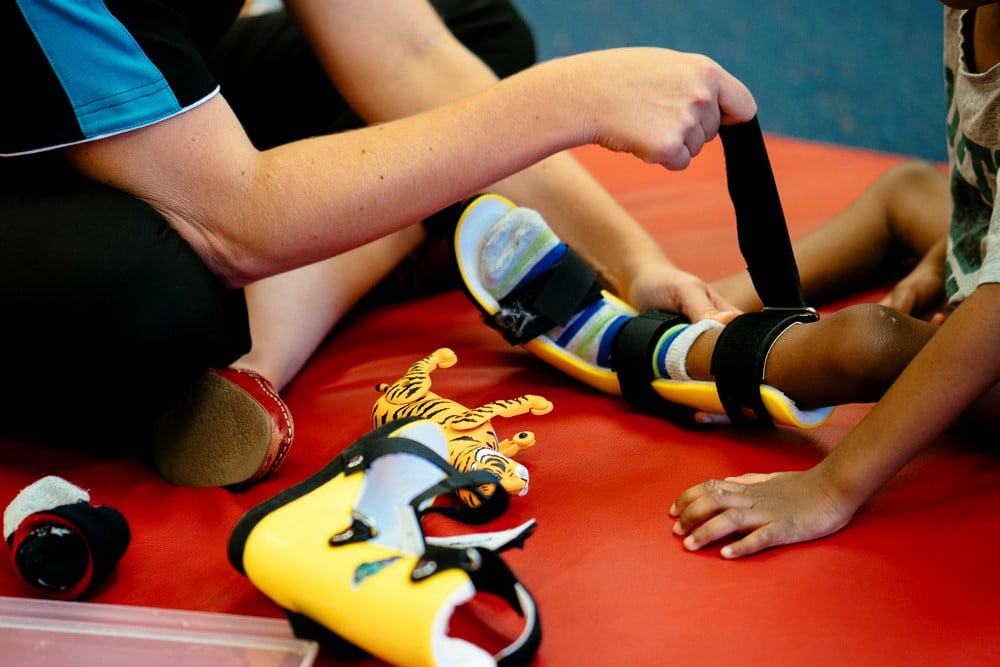 Occupational Therapist assists child with leg splints